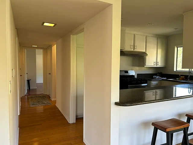 Hallway to the large main level bedroom and hall bath. Also leads to carport on the main level.