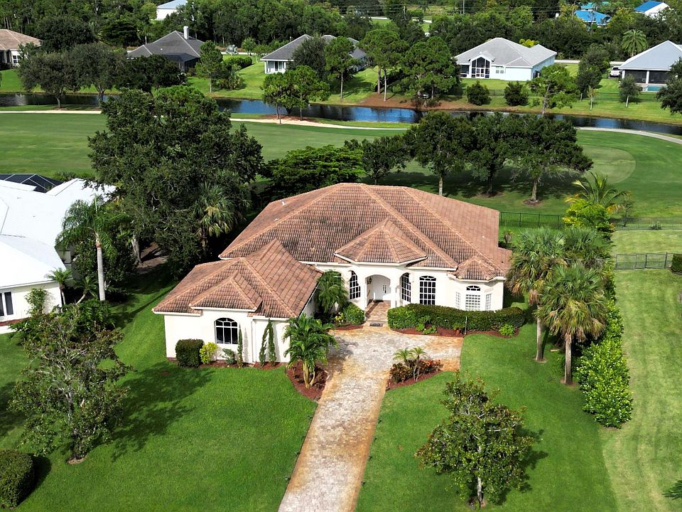 Front aerial with 3rd hole of the Cape Club of Palm City golf course behind