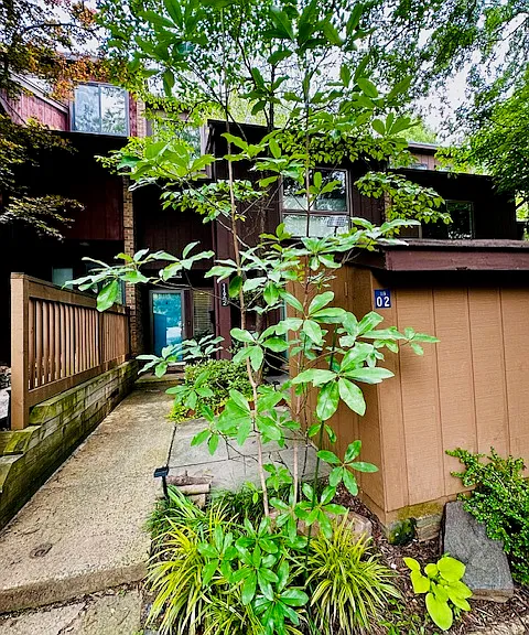 Step through the charming front entrance, where you're welcomed by a private azalea garden in full bloom, creating a vibrant and serene first impression. This peaceful outdoor space offers both privacy and natural beauty, with seasonal color.