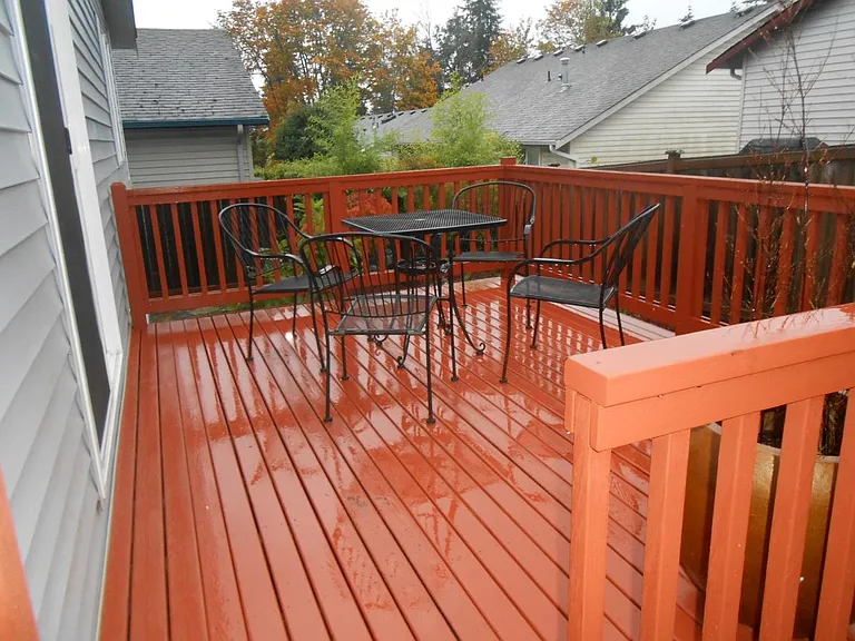 Photo shows old deck. Brand-new, newly built deck is much larger! Perfect for outdoor relaxing and entertaining. Enjoy a fully fenced backyard offering complete safety and privacy.