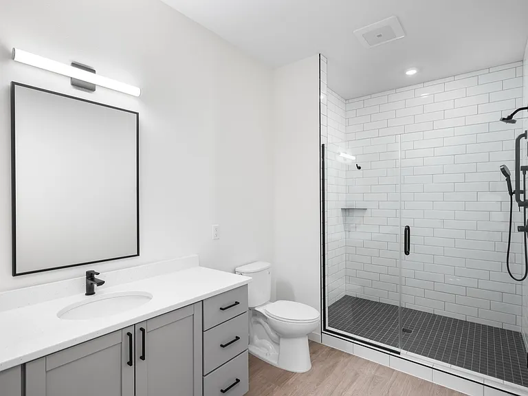 Modern bathroom with elegant glass shower, sleek gray vanity, and stylish tile design. Modern bathroom with elegant glass shower, sleek gray vanity, and stylish tile design.