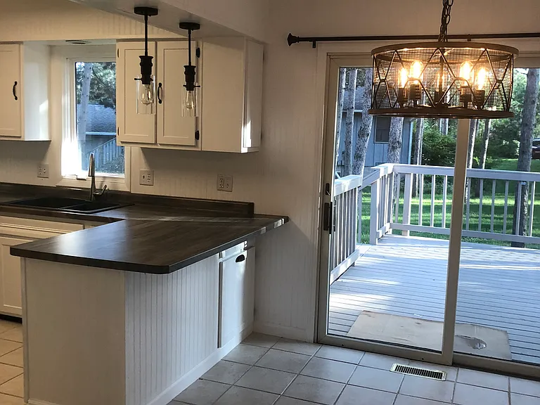 Dining room next to kitchen. Walk out deck overlooking backyard.
