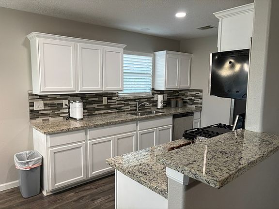 Newly remodeled kitchen with stove, refrigerator and dishwasher.