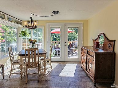 Darling dining area,  brings in a ton of light and leads out to the entertainment deck.