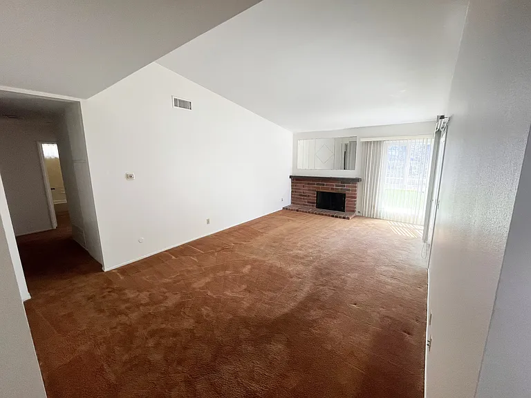 Front door foyer to living room and adjacent hall way.