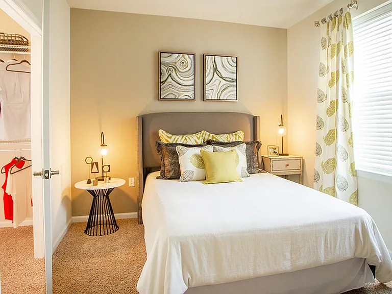Queen sized bedroom featuring plush wall to wall carpeting
