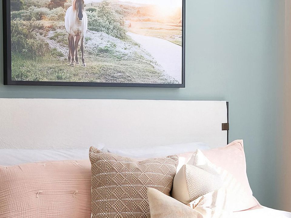 Spacious bedroom with tall ceilings and light green accent wall