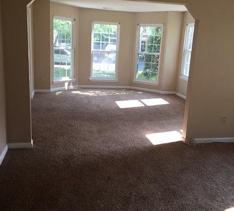 Living room with a bay window facing the front of the house.