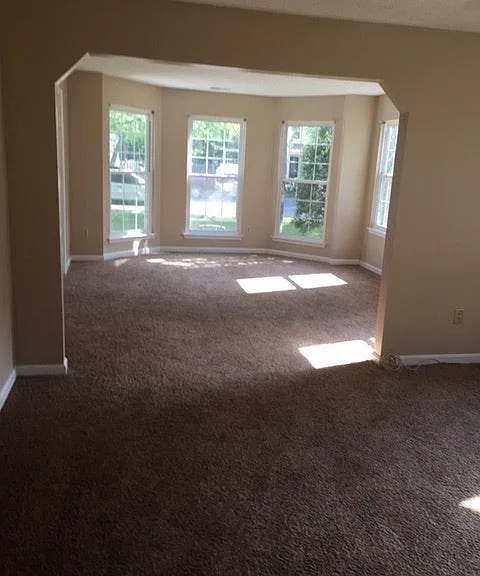 Living room with a bay window facing the front of the house.