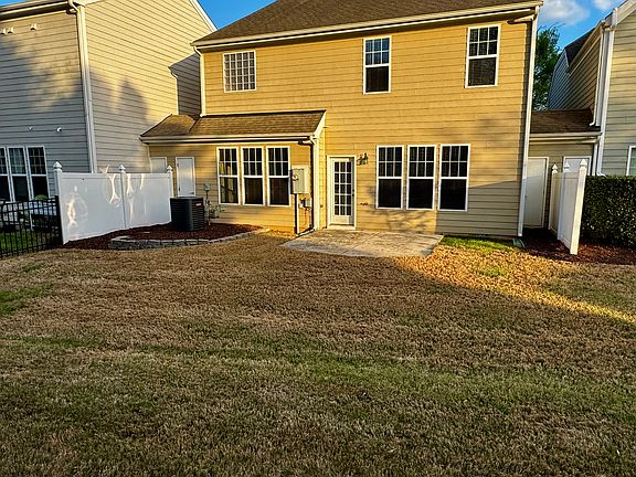 Huge backyard with lots of privacy, patio and two storage units on either side.