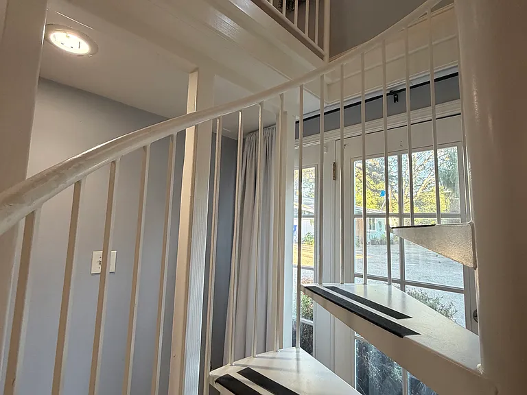 Staircase, showing the railings and first and second floors.