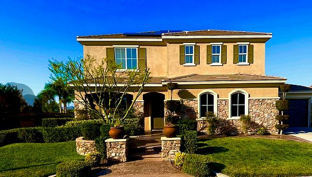 Stunning exterior illuminated by warm sunset views with picturesque mountains visible from the front porch and backyard.