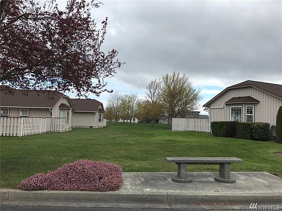Covered entry with one step entry, storm door and bay window.