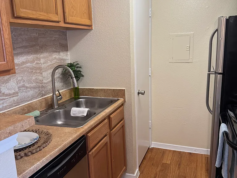 Kitchen with a large pantry, a beautiful backsplash, and stainless steel appliances.