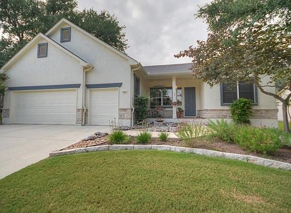A Front Sitting Porch and Golf Cart Garage set this Sun City Texas Pecos apart from others, while the scenic back yard creates a park-like effect at the Large Screened Porch.