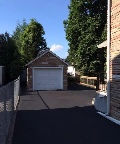 detached garage next to parking space & driveway