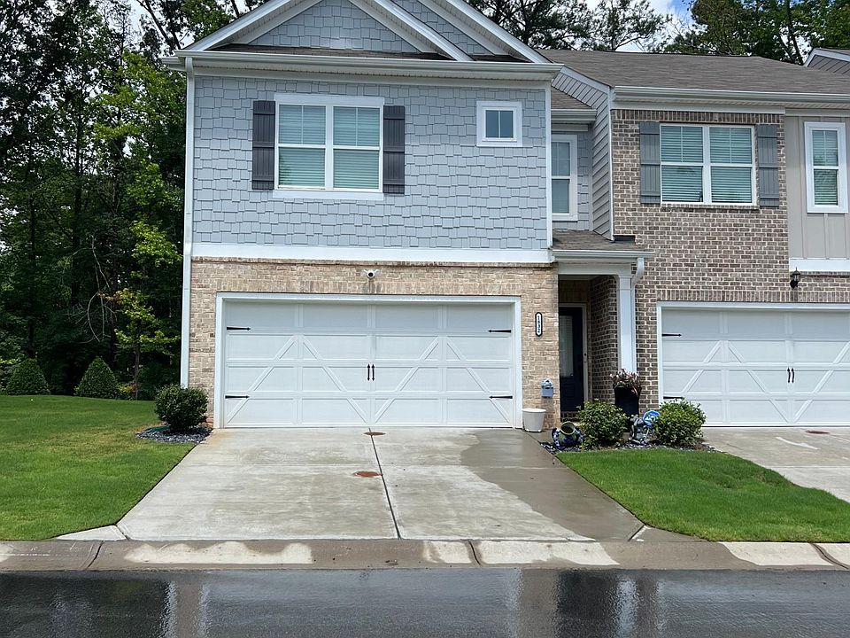 Front of home with garage. Front door entry to right.