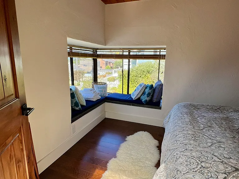 from the doorway of the upstairs bedroom looking towards the window seat
