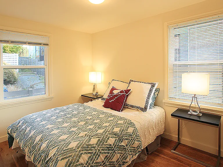 Small bedroom has windows facing North and East. Dimensions approximately 8.5 ft x 12 ft excluding closet.
