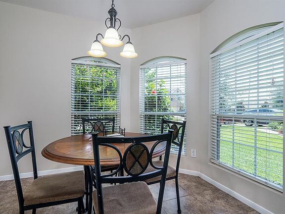 A cheery breakfast room with lots of windows is the ideal spot to sit with a morning cup of coffee and prepare for the day! This space would also make a great home office with all of this precious light!