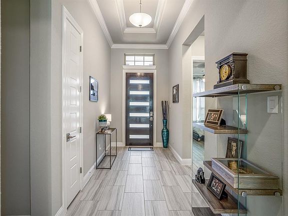 Impressive entry features a tray ceiling with upgraded lighting and beautiful neutral paint palette.