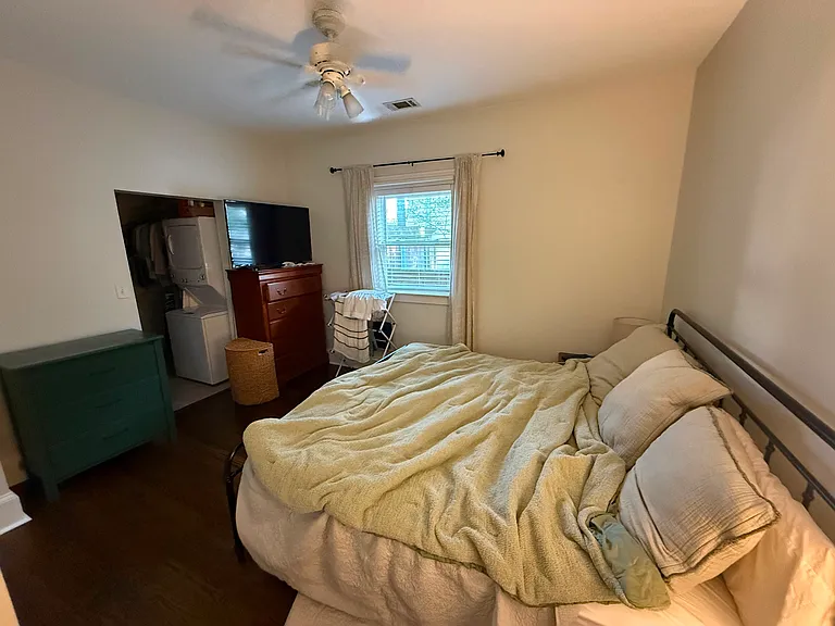 master with small ensuite bathroom and stack laundry in walk in closet