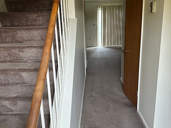 Entry way to upstairs, kitchen, half bath and living area.