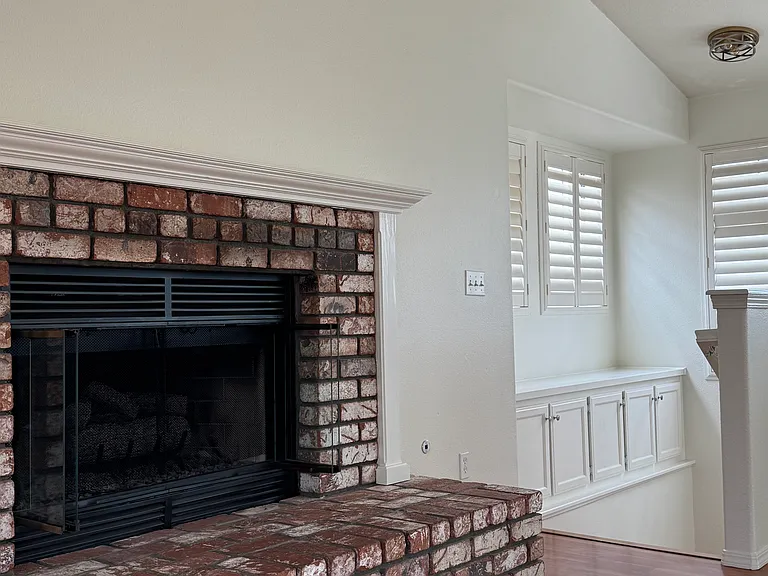 View from Living Room into Light and Bright Stairway with Storage and Display Area