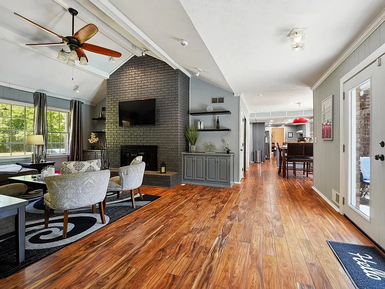 Living Room with TV, Fireplace & access to Garage & Upper Back Patio -Main Level
