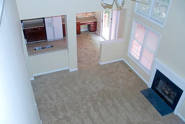 Living room with beautiful bright windows and views. Gas log fireplace. White appliances have been updated to SS. See other pics.