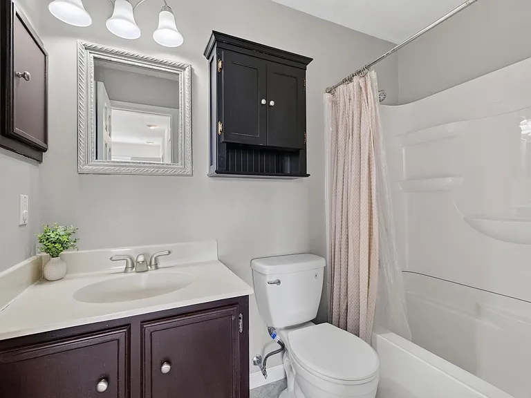 Full bathroom in rear bedroom. New shower/tub combo.