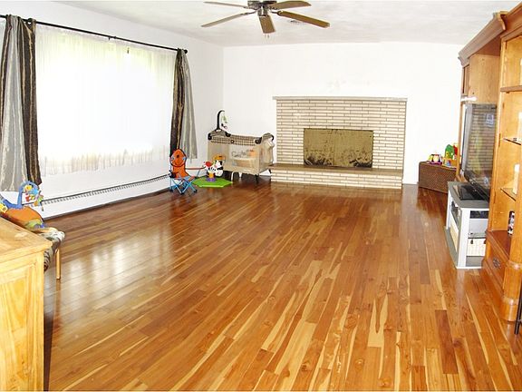 Family room with fireplace and hardwood flooring
