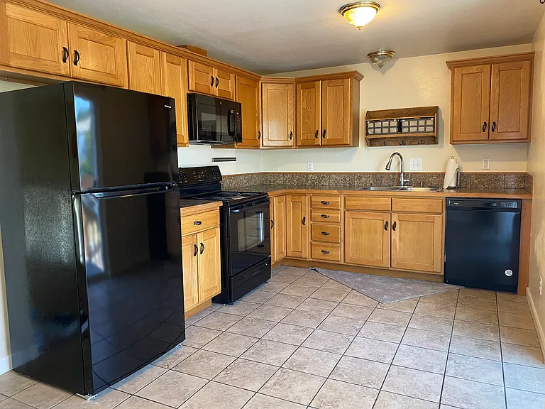 Tile kitchen with granite counters .