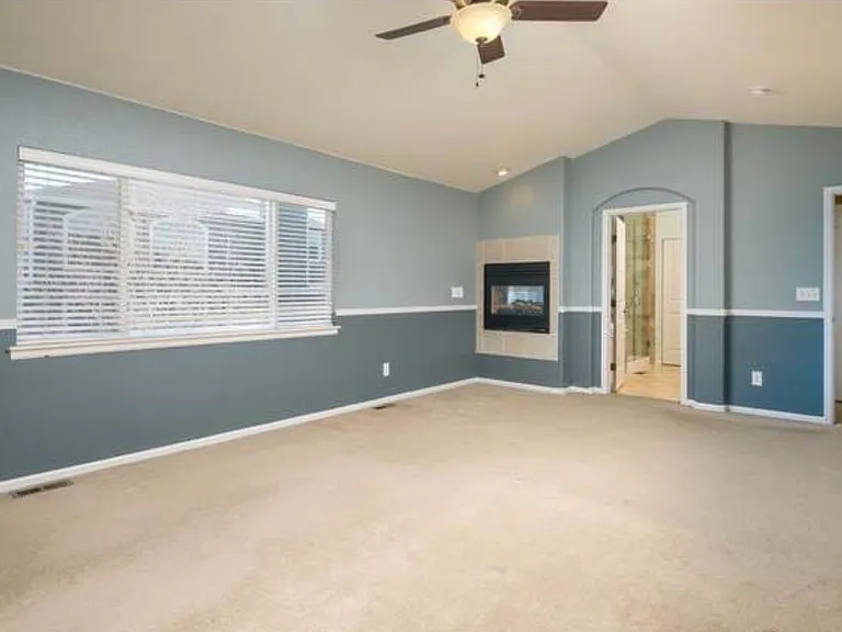 Master with vaulted ceilings and fireplace