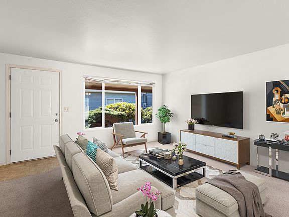 Living room with large front window ( Staged)