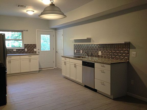 Sink, dishwasher, back door.