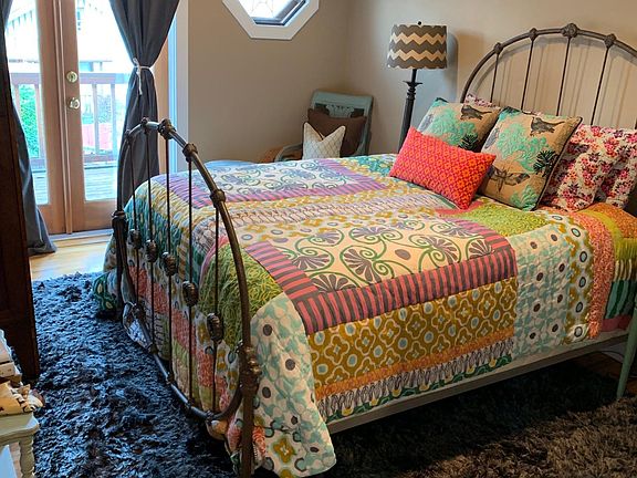upstairs master bedroom with French doors leading to elevated back deck
