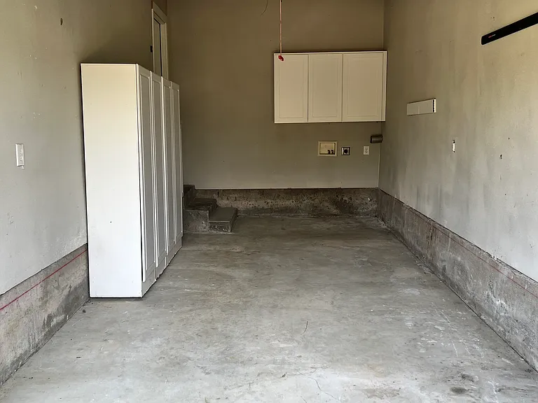 Garage
Features storage cabinets on the left and above the washer/dryer hookups.