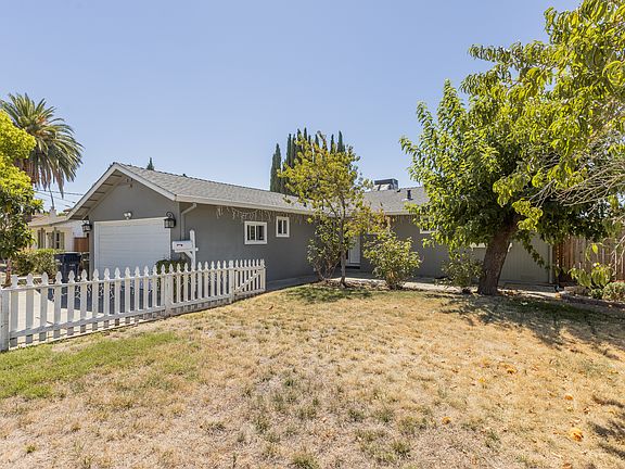 Front view with lawn and peach tree