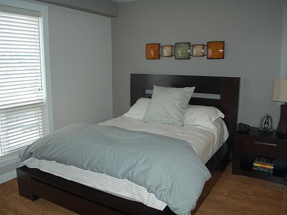 Bedroom with walk through closet leading to the bathroom. Same flooring throughout the unit. East facing window with a view of the Space Needle and downtown.