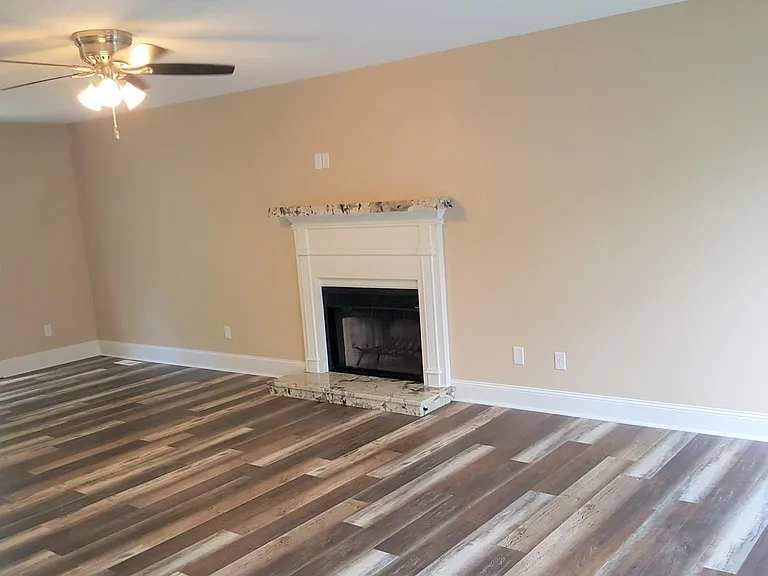 Another living room view with french doors leading to the ba