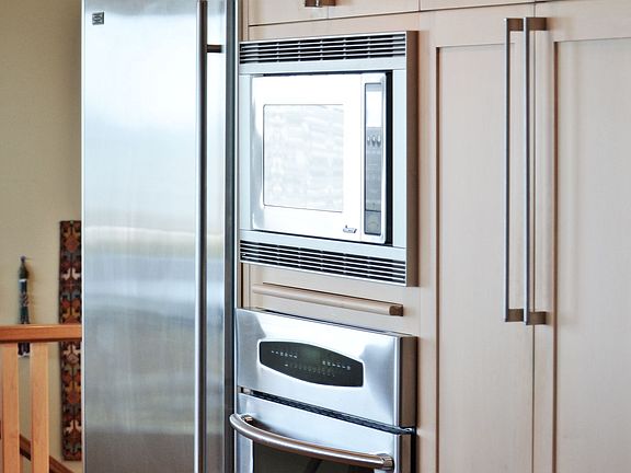 SubZero Refrigerator, in-wall oven and microwave cabinets