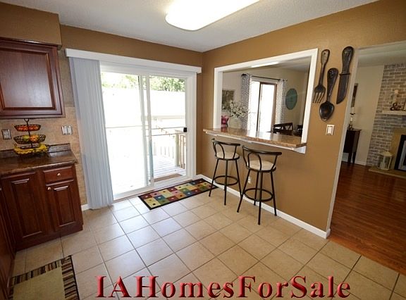 Kitchen and breakfast bar. Sliding door to deck.