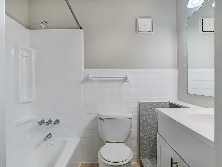 Modern bathroom design featuring a pristine white bathtub, sleek vanity, and elegant tile accents.