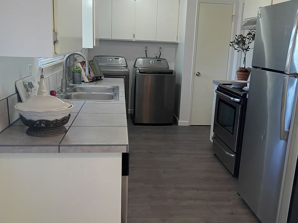 Efficient galley kitchen with stainless steel appliances throughout