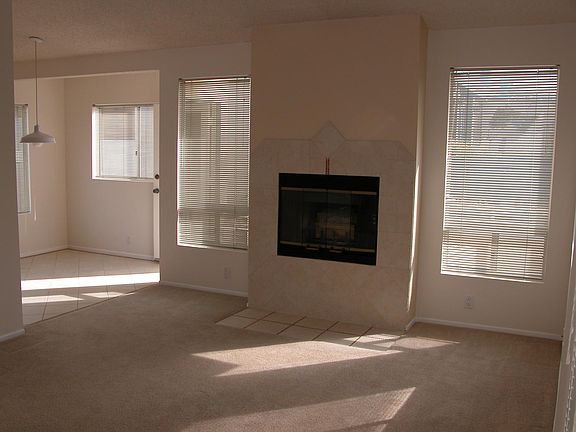 Living room with fireplace leading to dining room