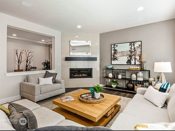 Living area with Electric Fireplace and recessed lighting, next to the dining area
