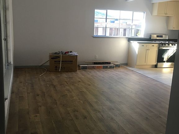 living room new floors throughout with high ceiling