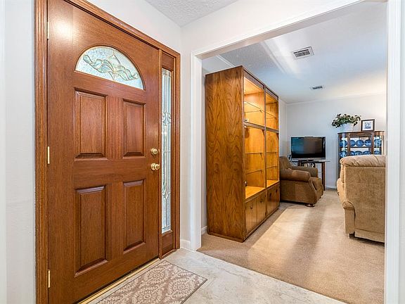 Solid wood front door and recent tile in the entry.