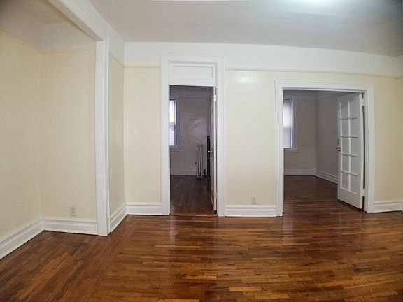 Living room from foyer facing both bedrooms and alcove to the left.